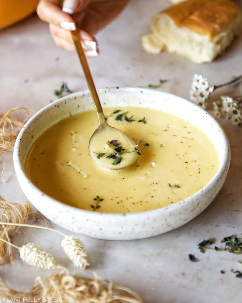 image of spoon in cheesy cauliflower soup