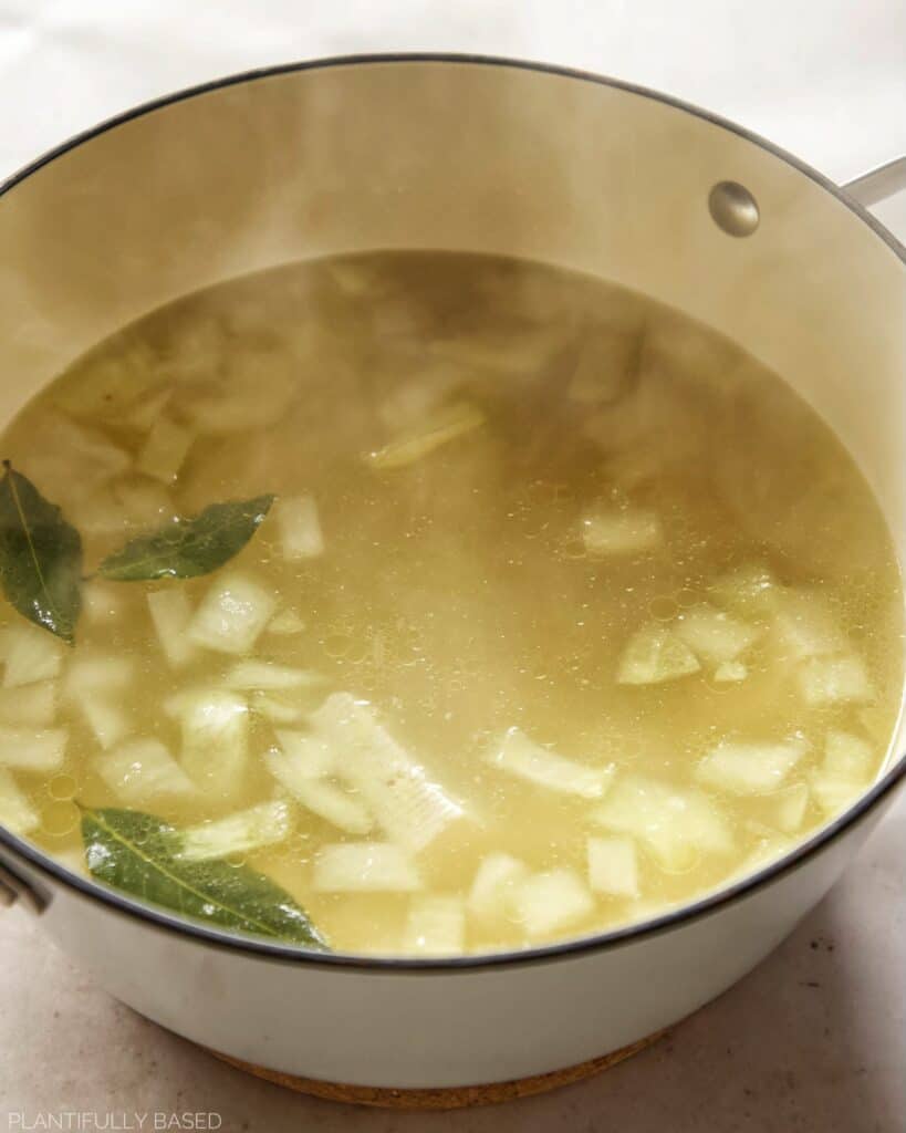 image of broth with tofu, onions, garlic
