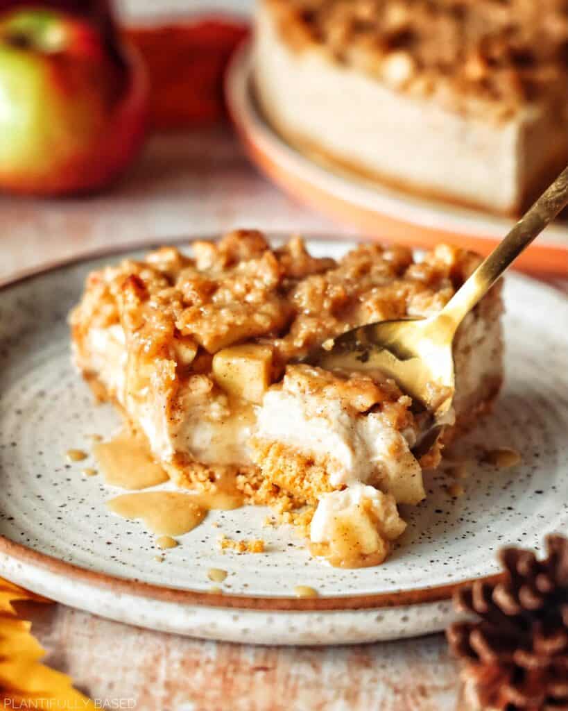 image of vegan apple crumble cheesecake with spoon