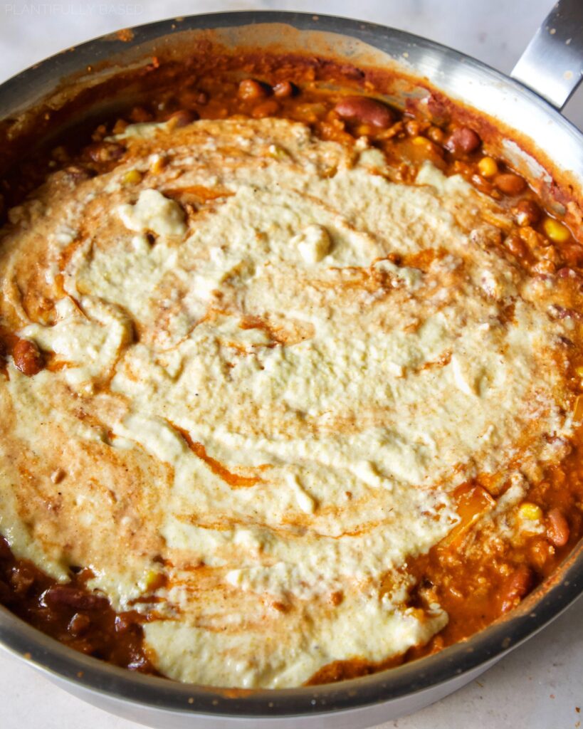 image of cornbread batter and chili in pan