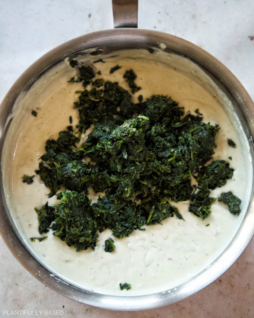 cooked spinach in vegan cream sauce