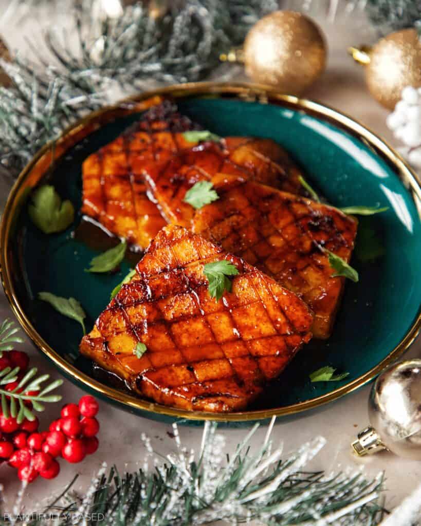 vegan tofu ham in a dish with garland and ornaments
