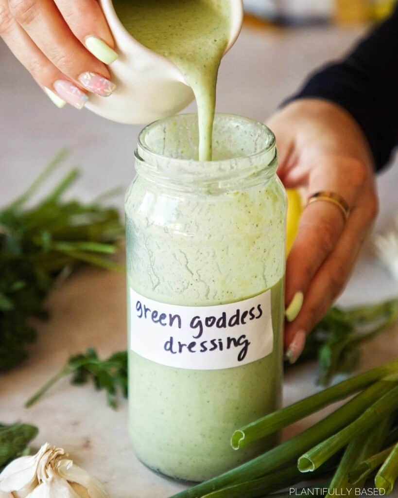 image of vegan green goddess dressing being poured