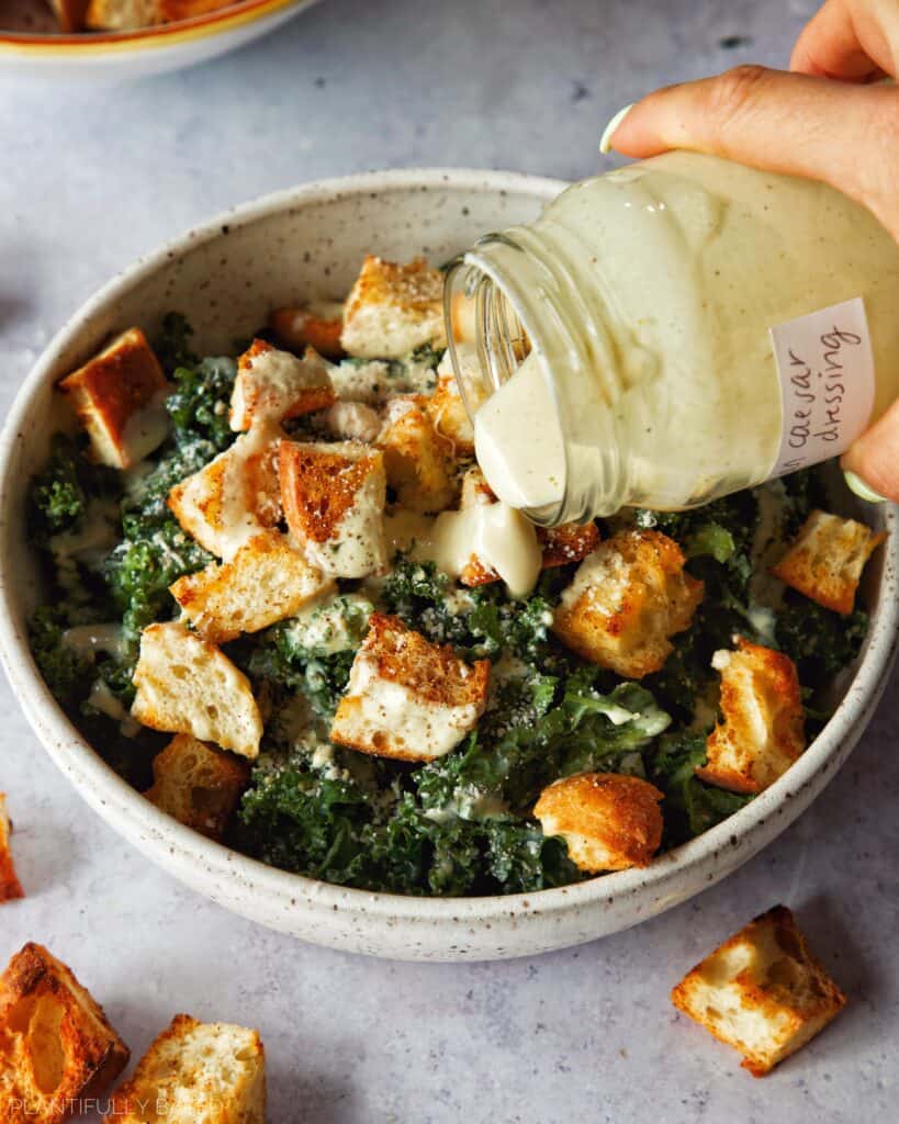 image of vegan caesar salad dressing being poured