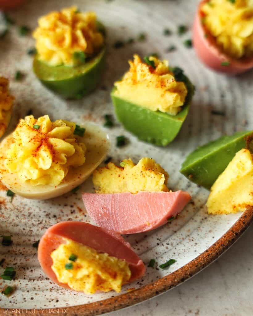 image of colorful vegan deviled eggs cut in half