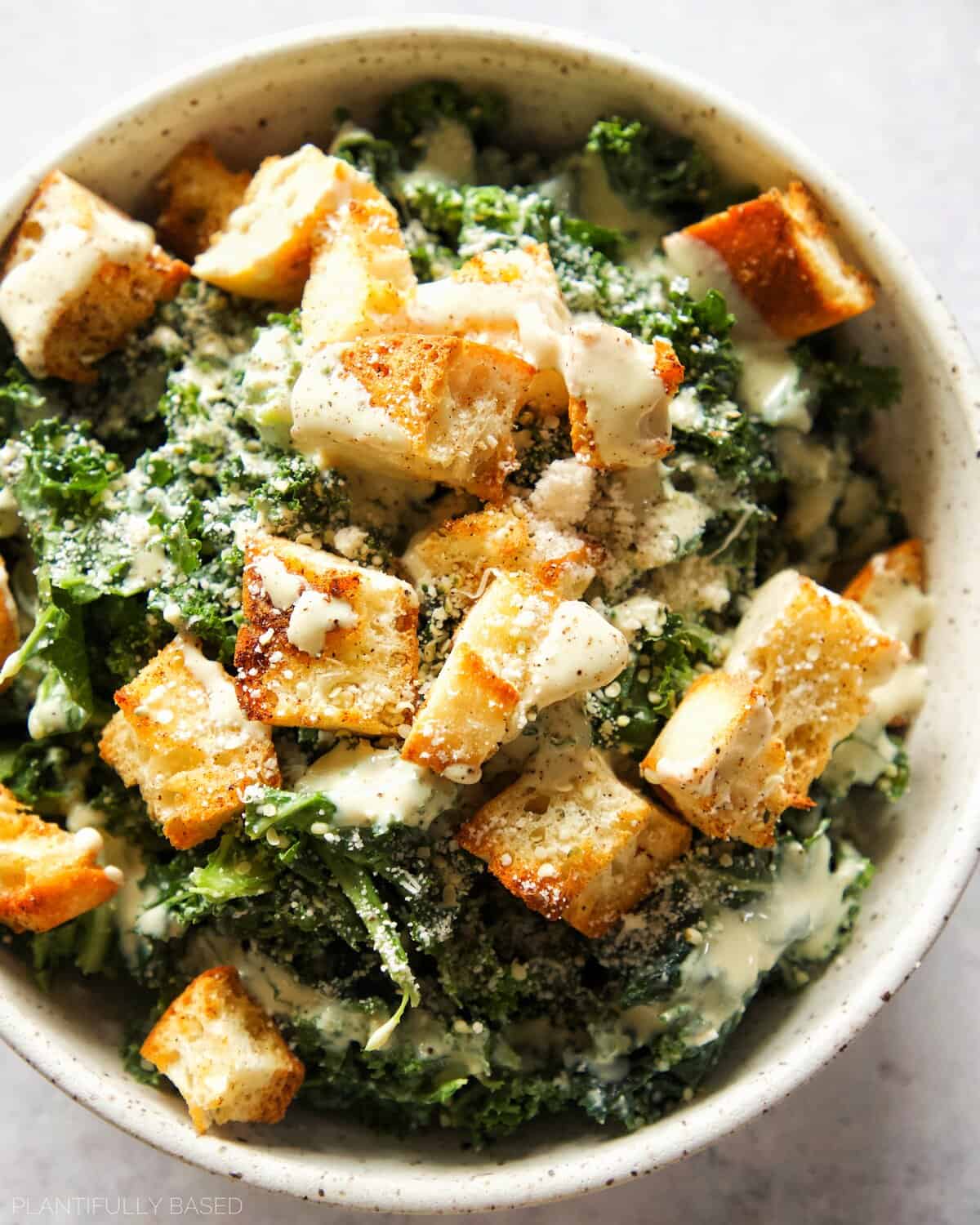 image of vegan Caesar salad dressing on a salad