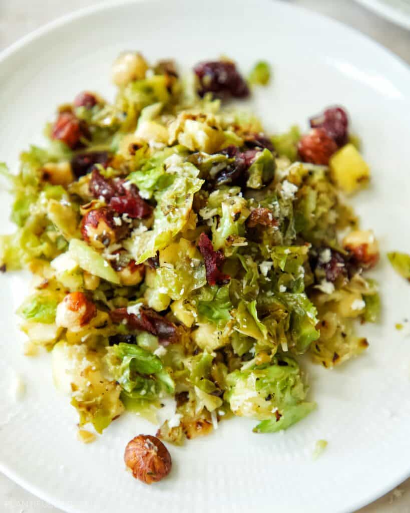 Holiday Brussels Sprouts Salad with Vegan Cheese, Craisins, and Hazelnuts