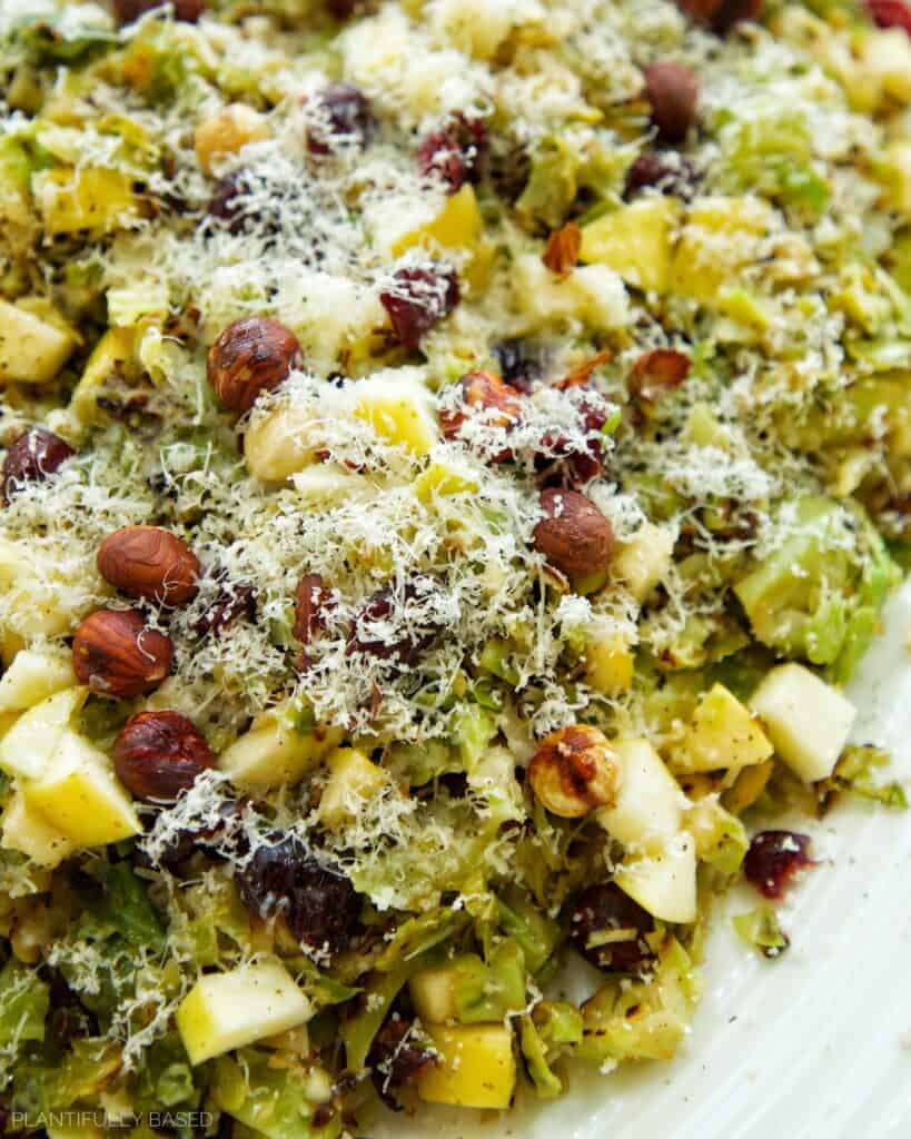 Holiday Brussels Sprouts Salad with Vegan Cheese, Craisins, and Hazelnuts