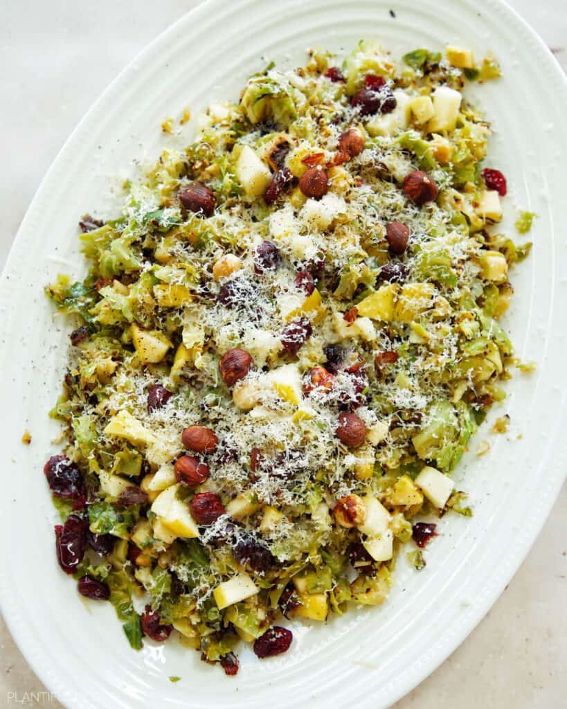 Holiday Brussels Sprouts Salad with Vegan Cheese, Craisins, and Hazelnuts