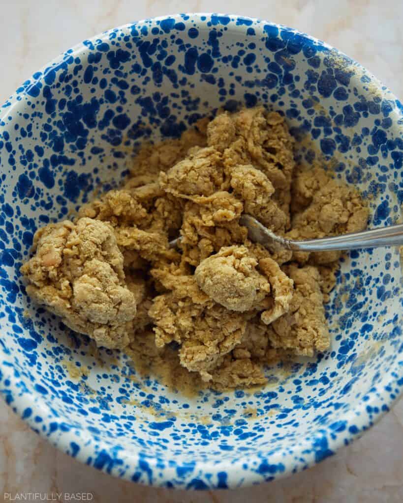 adding in vegetable broth to help form seitan dough