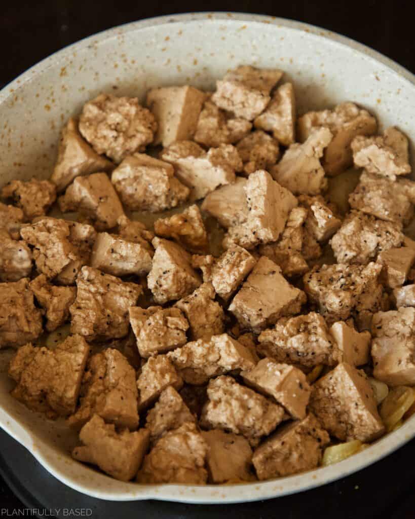 tofu is cooking on the stove