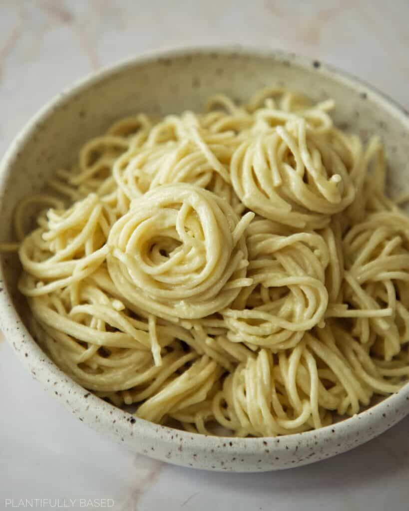 vegan alfredo sauce on pasta in a bowl