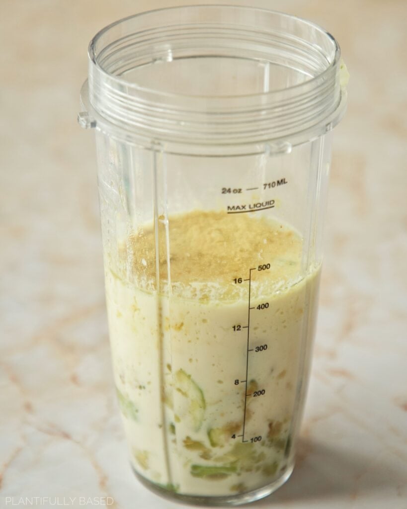 blending up the cooked vegetables, non-dairy milk, and nutritional yeast
