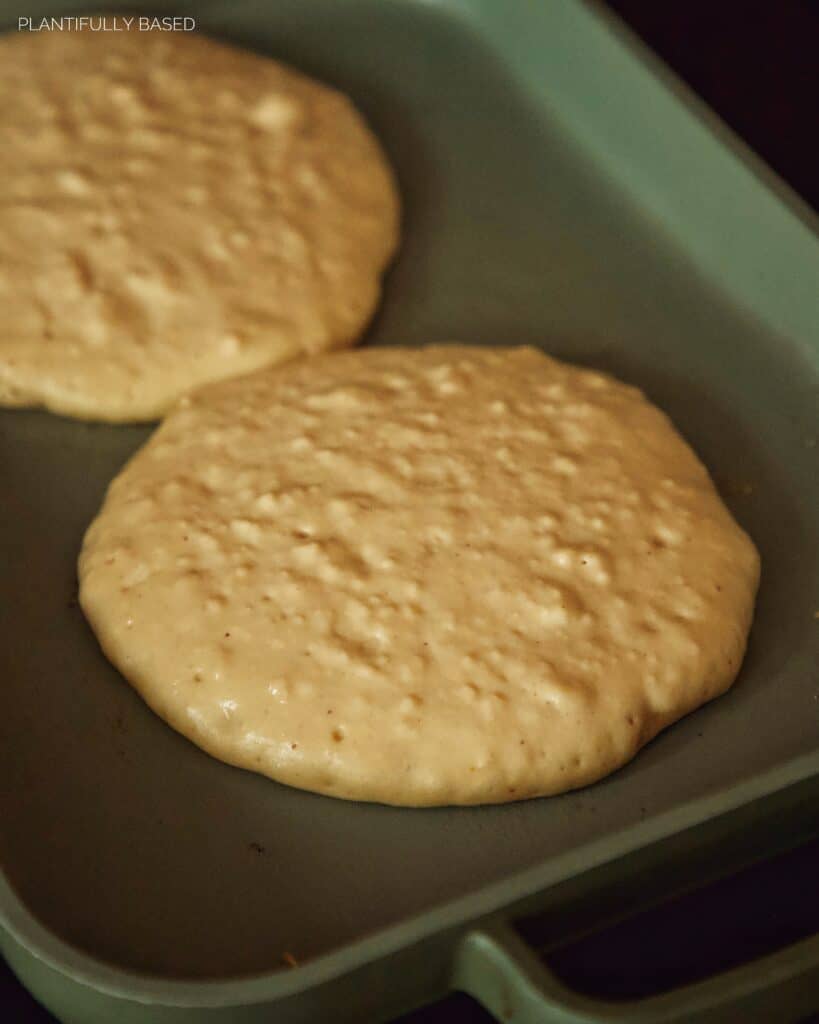 high protein pancakes cooking on griddle
