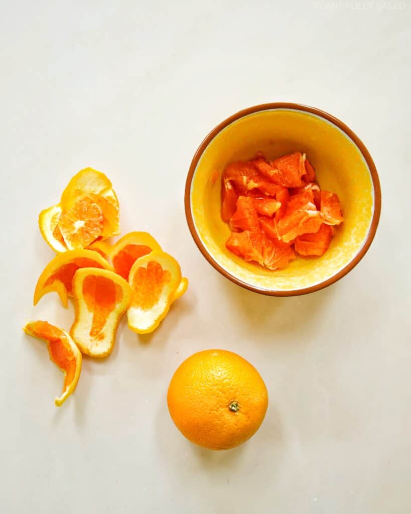 cutting up oranges for orange and white bean salad
