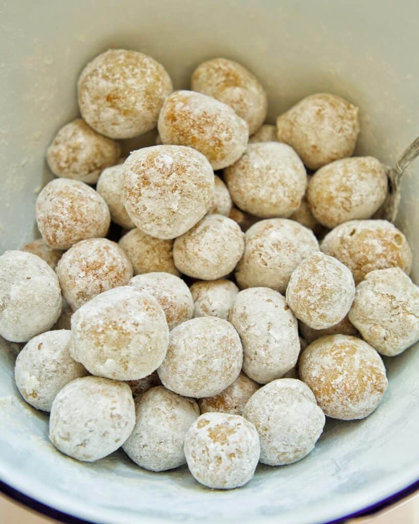covering high protein donut bites in powdered sugar